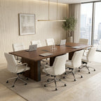 Rectangular conference table in walnut with recessed power grommets, set with laptops and white leather chairs in a boardroom
