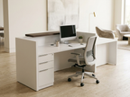 ADA compliant reception desk in white laminate beside a bright showroom lounge