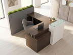 Overhead view of the L-shaped reception desk showing its raised glass transaction ledge