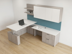 Aerial view of a light gray L shaped desk, white top and teal tackboard on a wood floor
