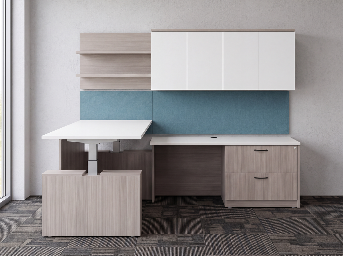 Light gray L shaped sit-stand desk with white overhead cabinet in a corporate office with carpet tile