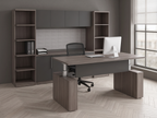 Corner desk with bookcase storage wall in an academic office with a herringbone floor and window