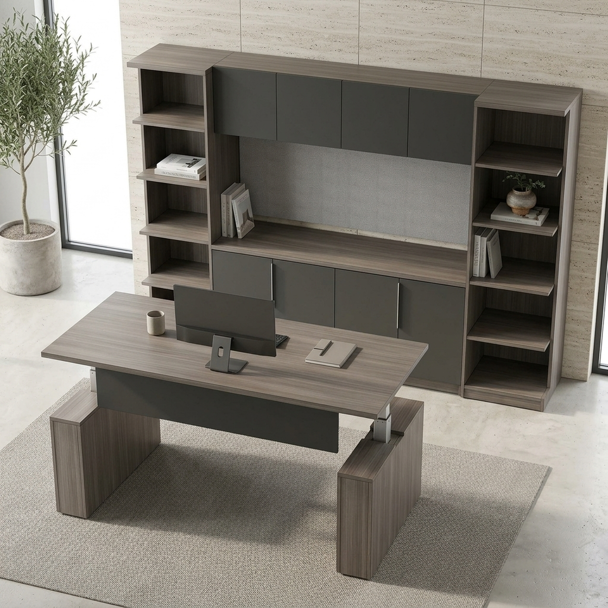Elevated view of a gray sit-stand desk facing a storage wall with credenza, hutch and bookcases
