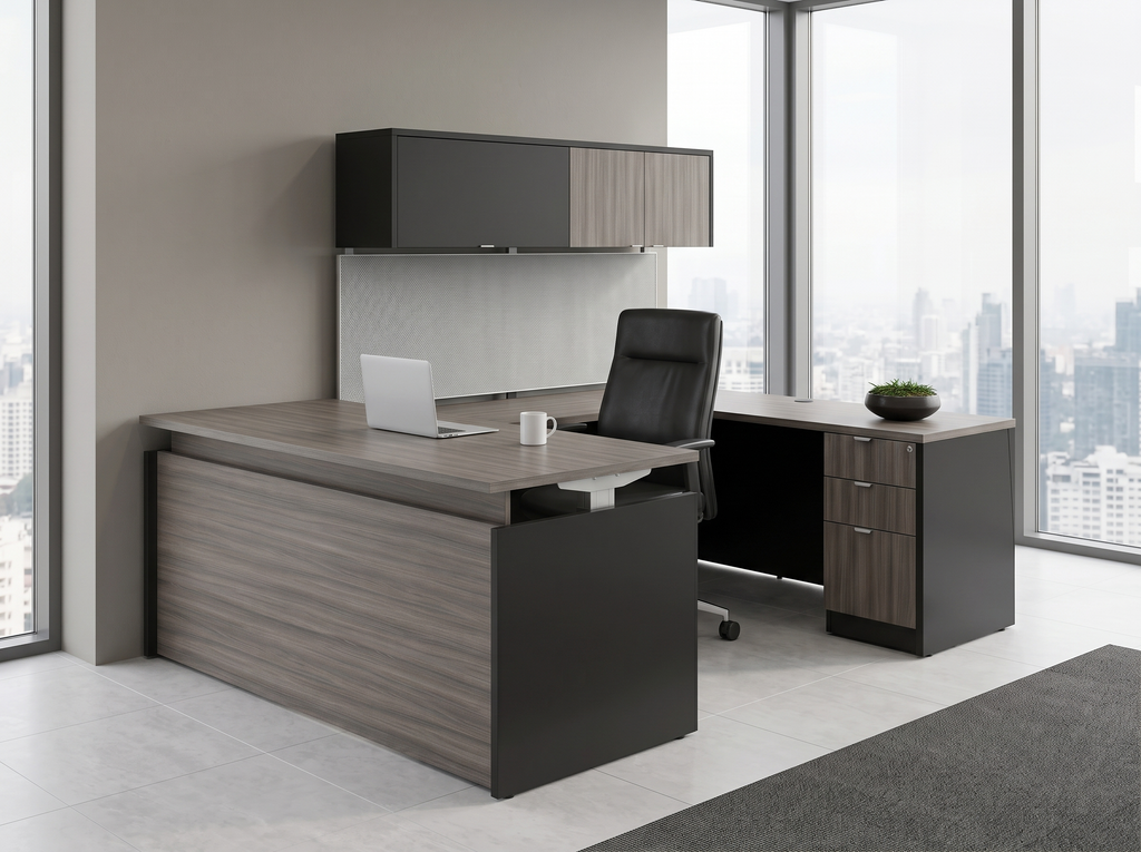 Gray woodgrain and charcoal sit-stand desk at seated height in a high-rise office with a black leather chair