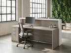 Operator side of the gray reception desk with drawer pedestal and green wall behind
