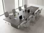 12 ft tapered conference table seating 10 to 12 in a bright white meeting room