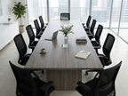 16 ft conference table on panel bases in a sunlit glass-walled boardroom