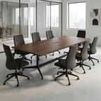 Three-quarter view of the walnut conference table showing the black trestle base and spine