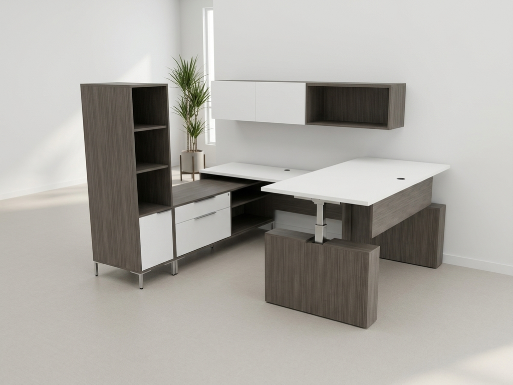Full view of a dark gray U shaped office desk with tower and overheads, plant in the corner