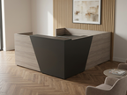 Gray U-shaped reception desk with storage against a wood-slat wall and herringbone floor