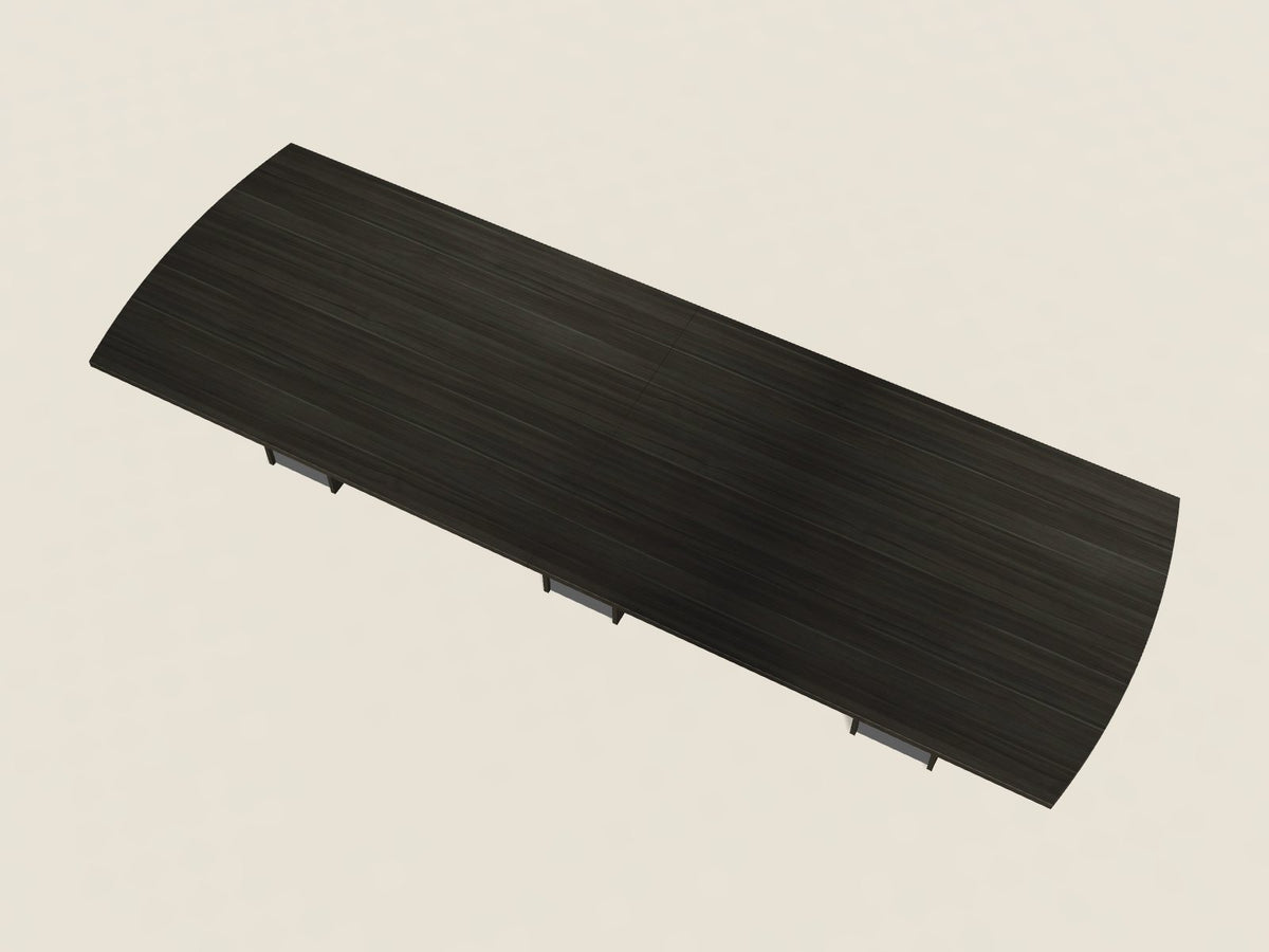 Bow-end conference table in Grigio Notte, a dark grey-brown woodgrain laminate, seen from above, with curved ends