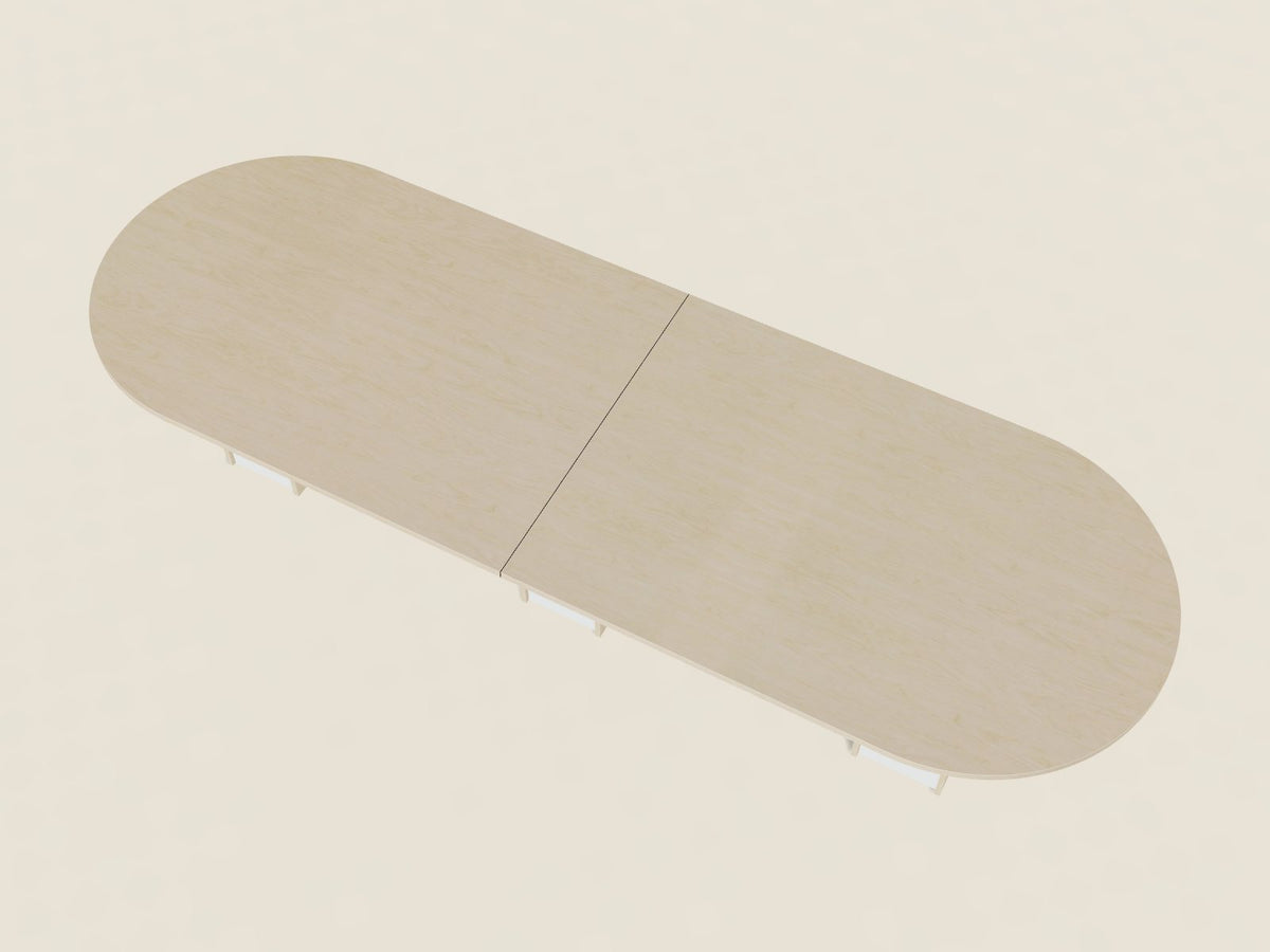 Racetrack conference table in Hardrock Maple, a light blonde woodgrain laminate, seen from above, with rounded ends