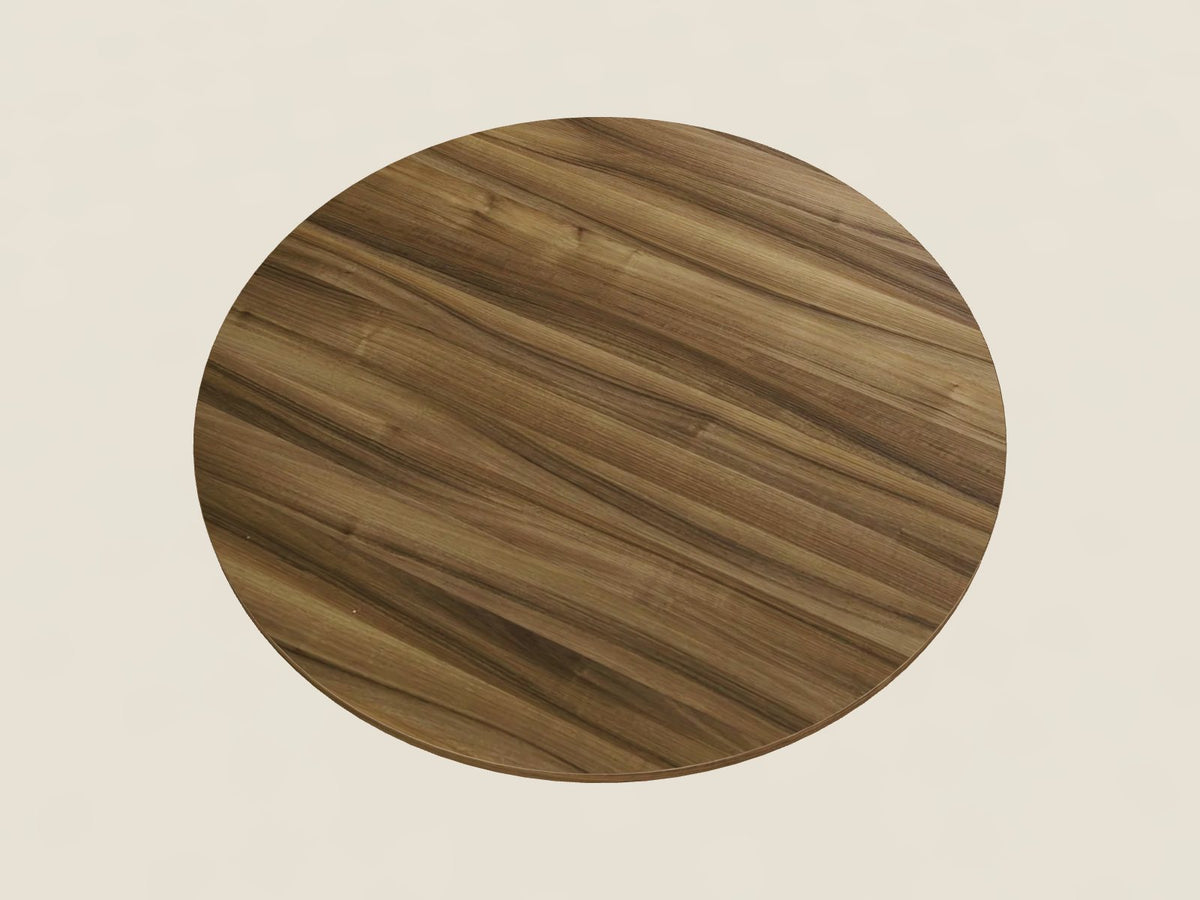 Round meeting table in Carmelo Mist, a warm medium brown woodgrain laminate, seen from above